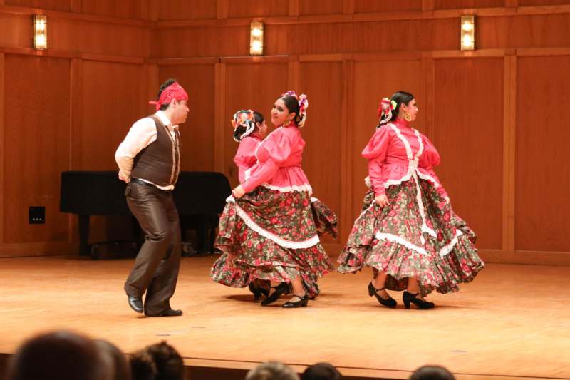 a group of people dancing on a stage