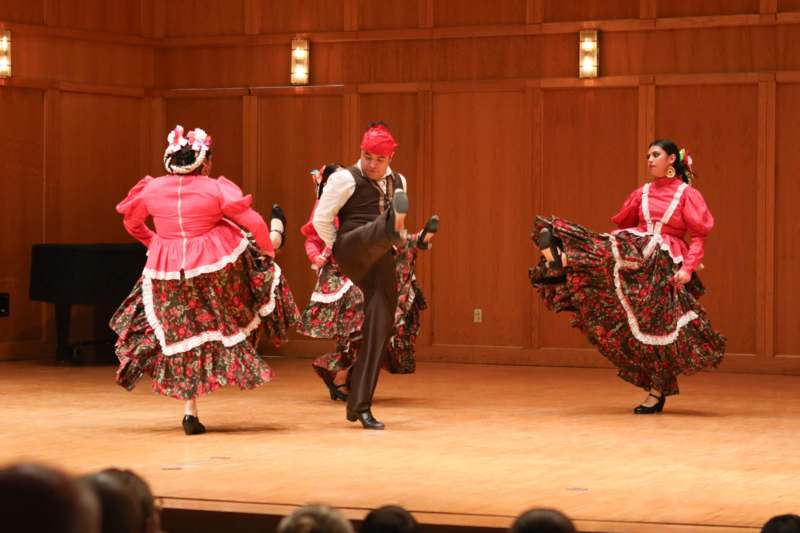 a group of people dancing on a stage