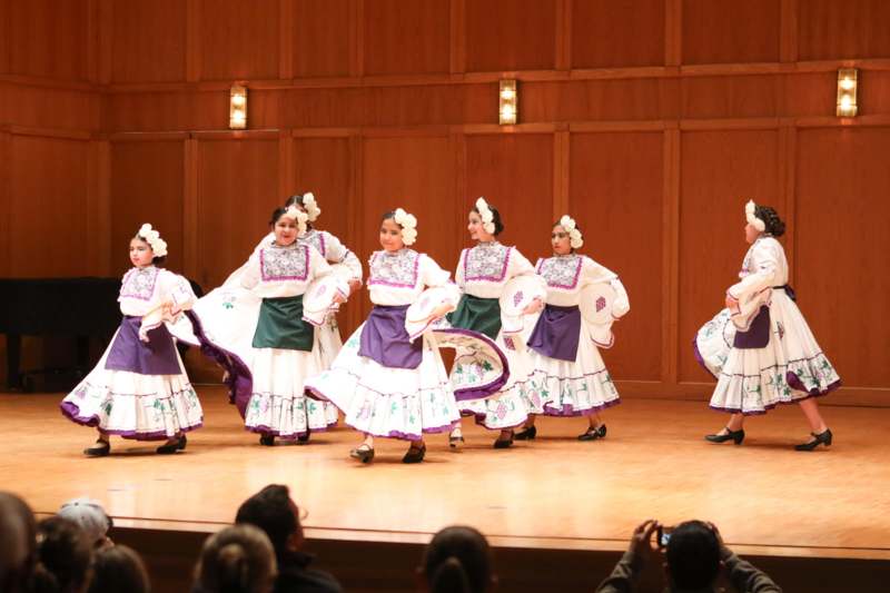 a group of women in clothing on a stage