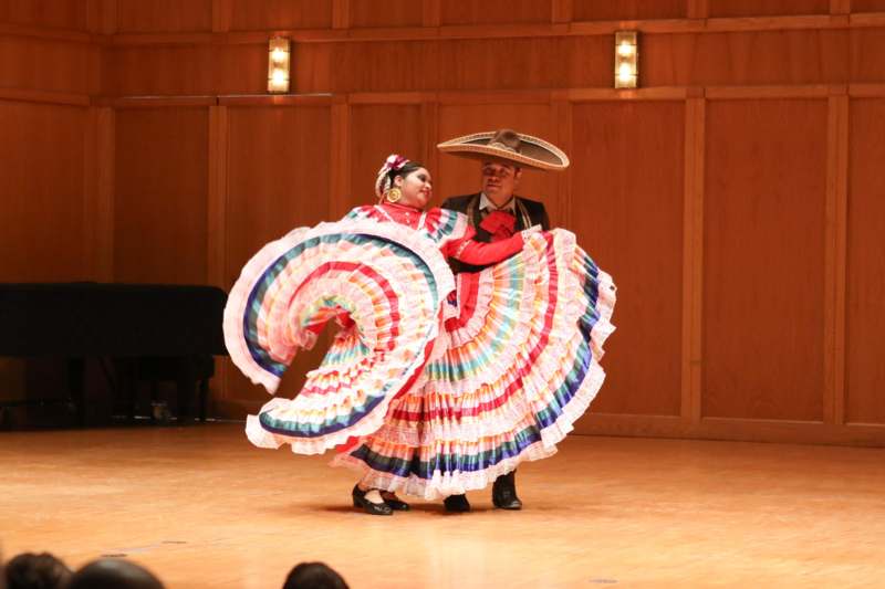 a man and woman dancing on a stage