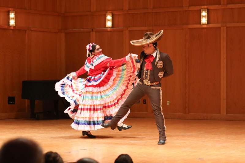 a man and woman dancing on a stage