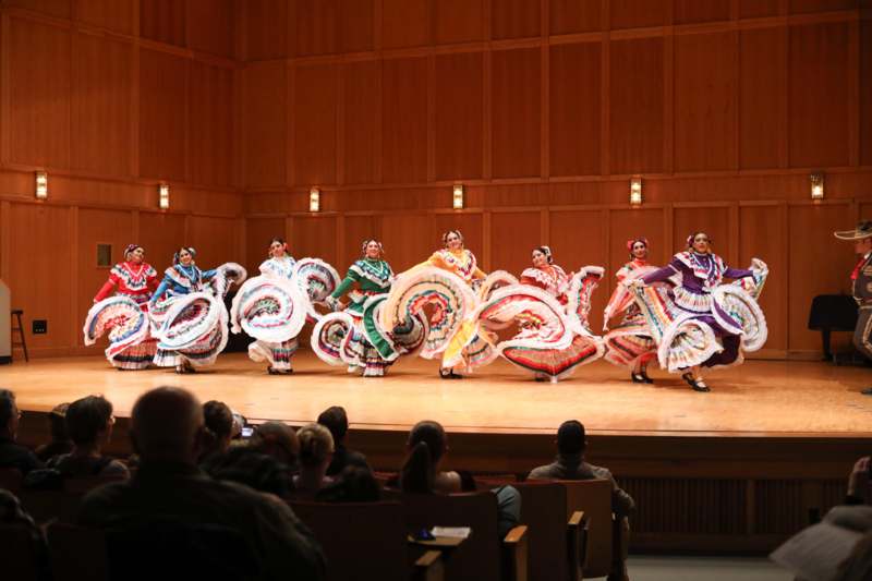 a group of women in colorful clothing on a stage