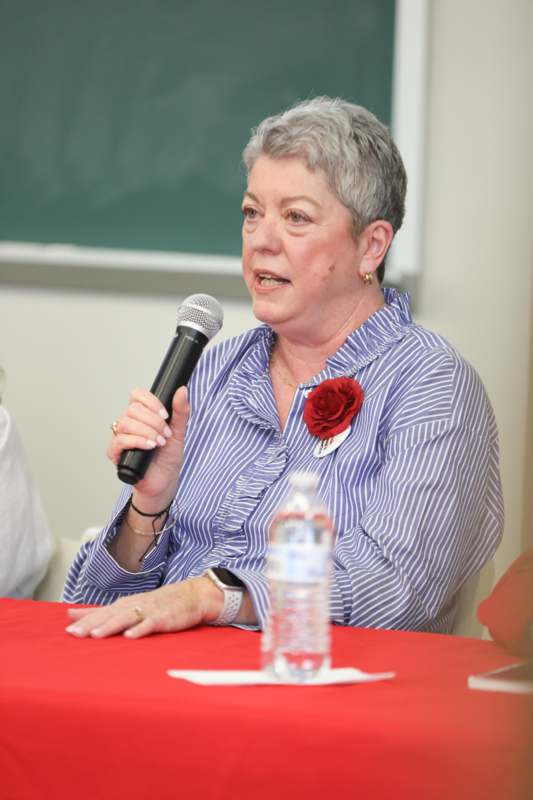 a woman speaking into a microphone