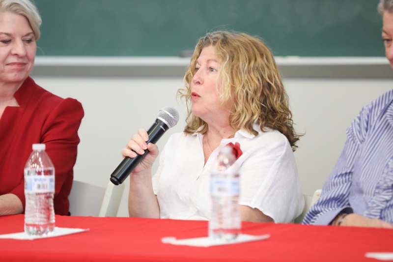a woman speaking into a microphone