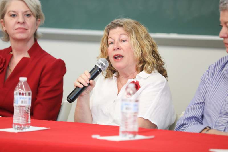a woman speaking into a microphone
