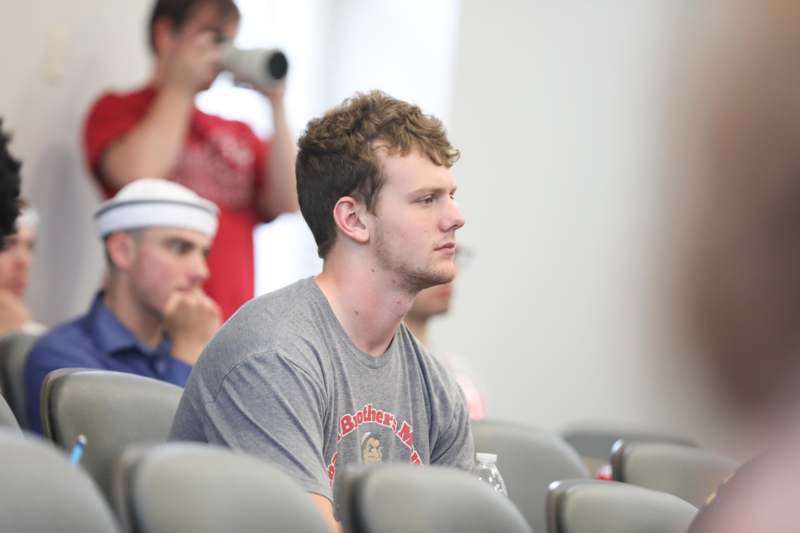 a man sitting in a lecture hall