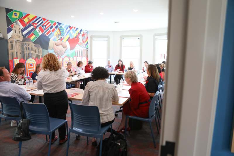 a group of people sitting at tables in a room