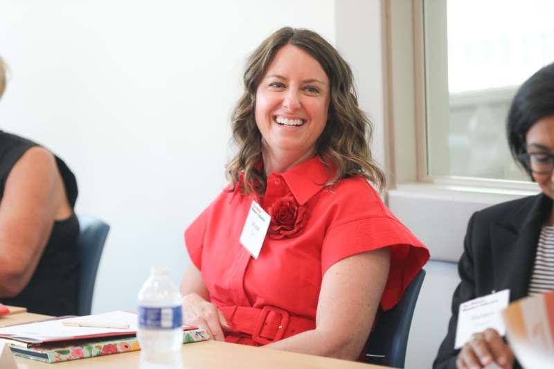 a woman in a red dress smiling