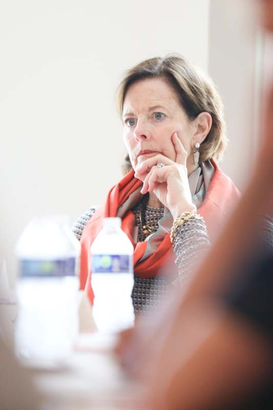 a woman with her hand on her chin