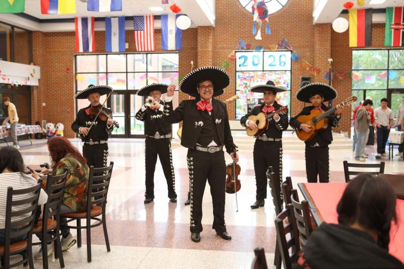 a group of people in mariachi clothing playing instruments