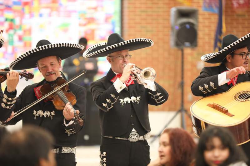 a group of men wearing sombreros playing instruments