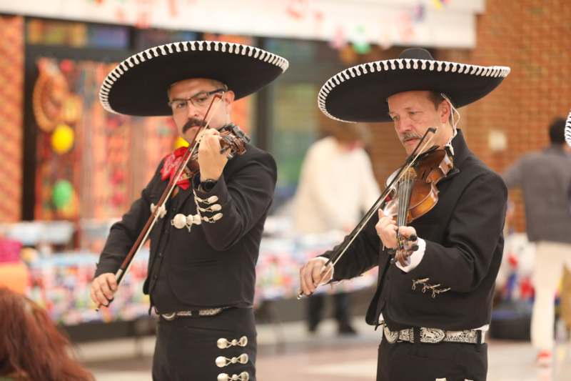 a couple of men wearing sombreros playing instruments