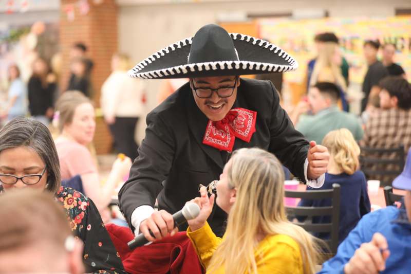 a man in a sombrero holding a microphone