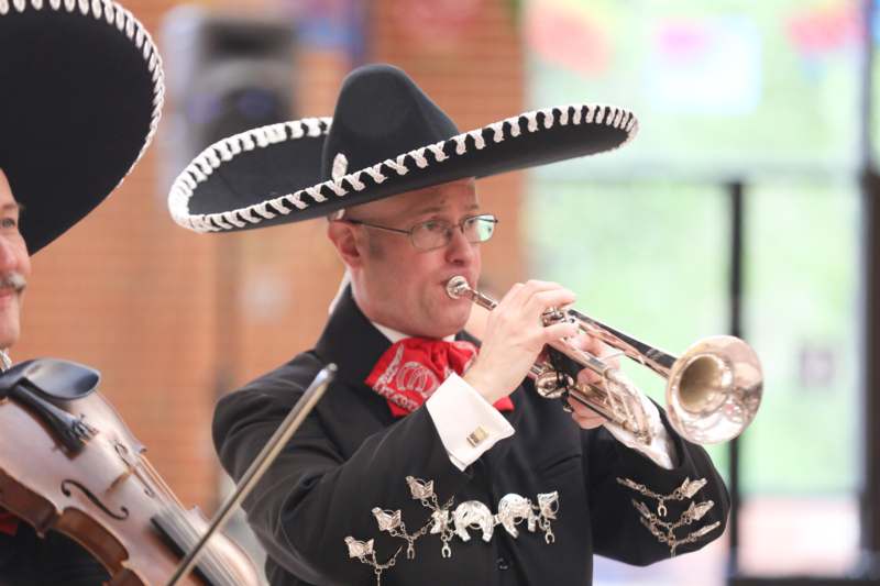 a man in a sombrero playing a trumpet