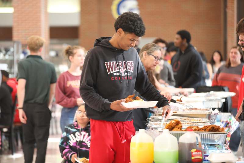 a man holding a plate of food
