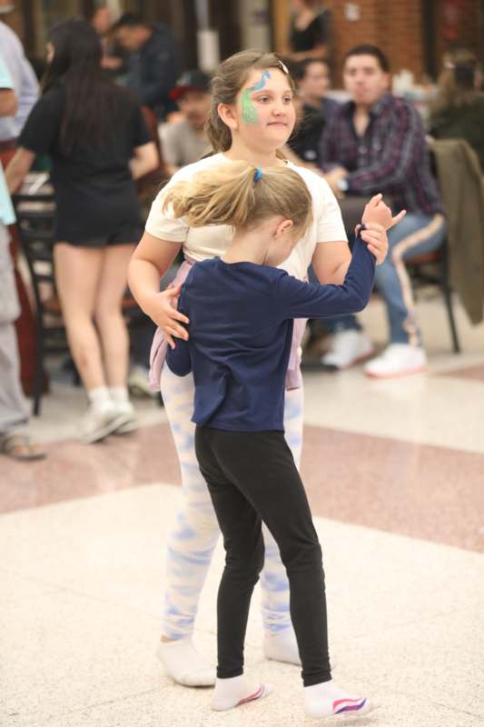 a girl holding a girl's hand