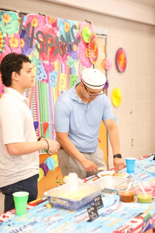 a man standing next to another man