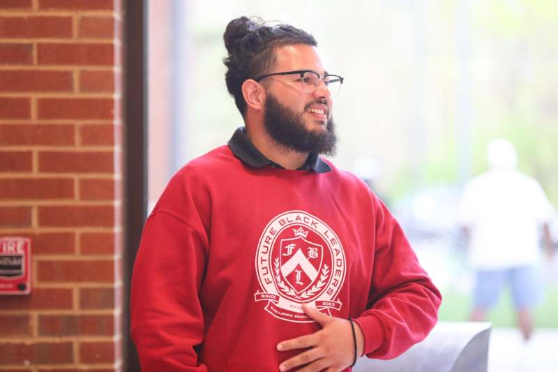 a man with a beard wearing a red sweatshirt