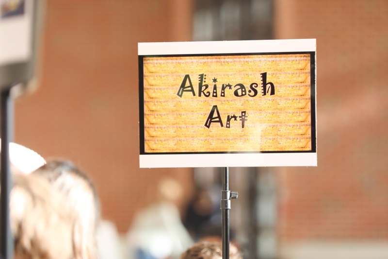 a sign with a yellow and black text