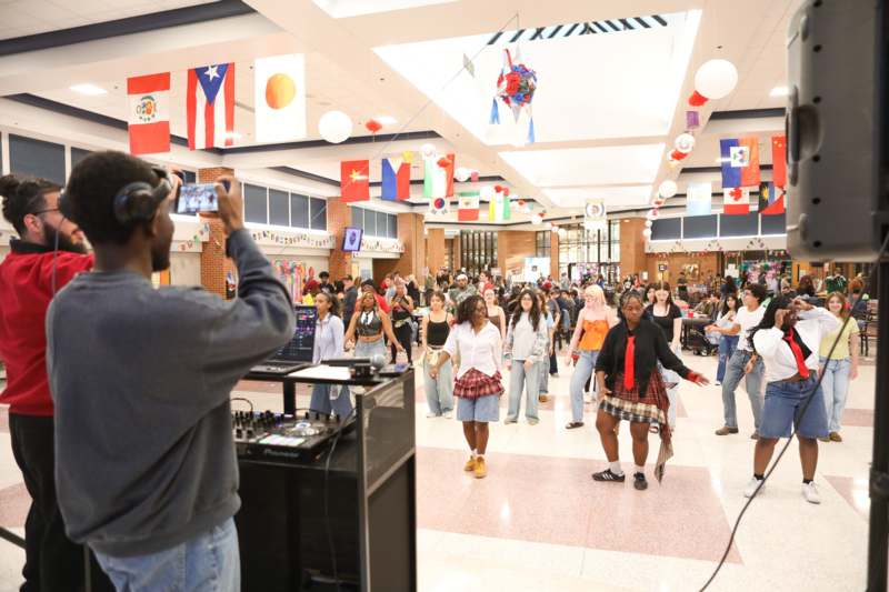 a man taking a picture of a group of people in a room