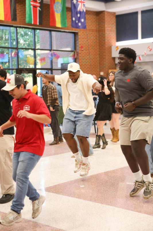 a group of men jumping in a room