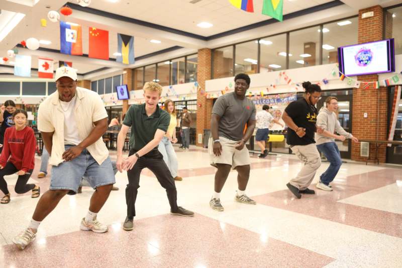a group of men dancing in a room