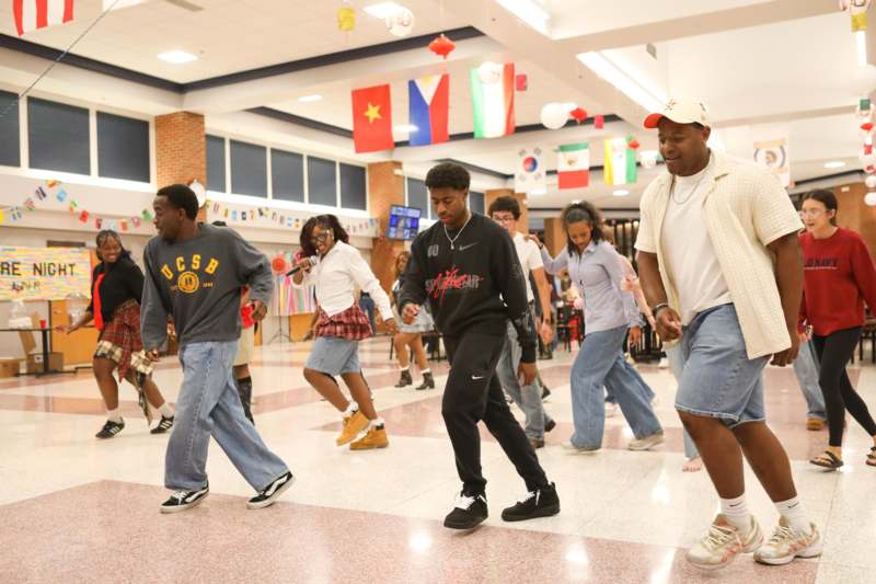 a group of people walking in a room