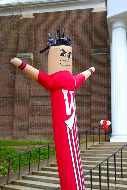 a inflatable man in front of a building