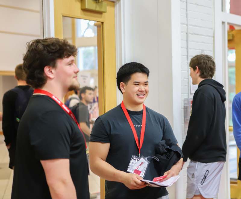 a group of men standing in a hallway