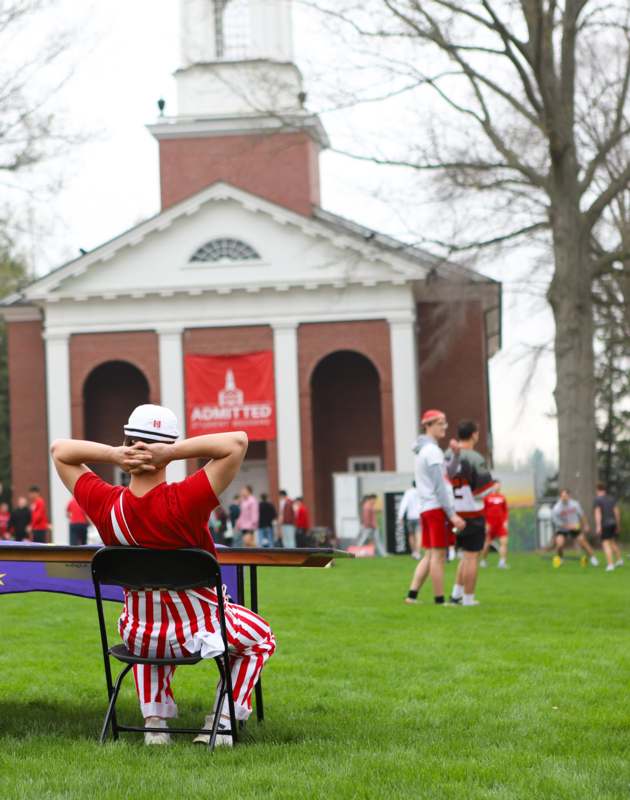 a man sitting in a chair in front of a building