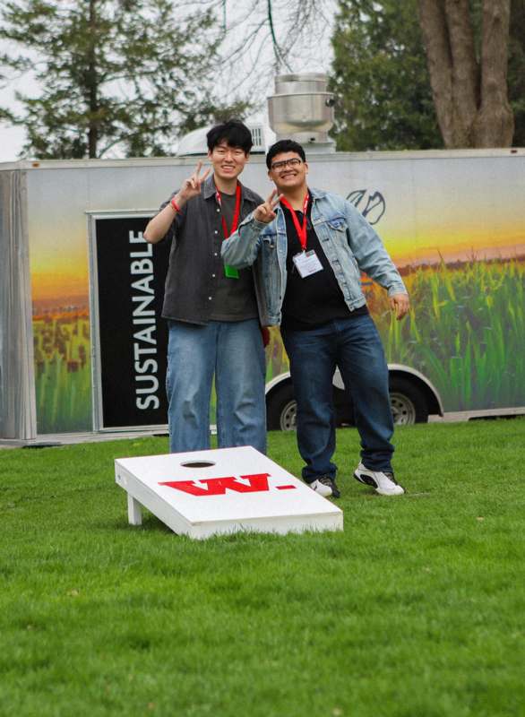 two men standing in a grassy area