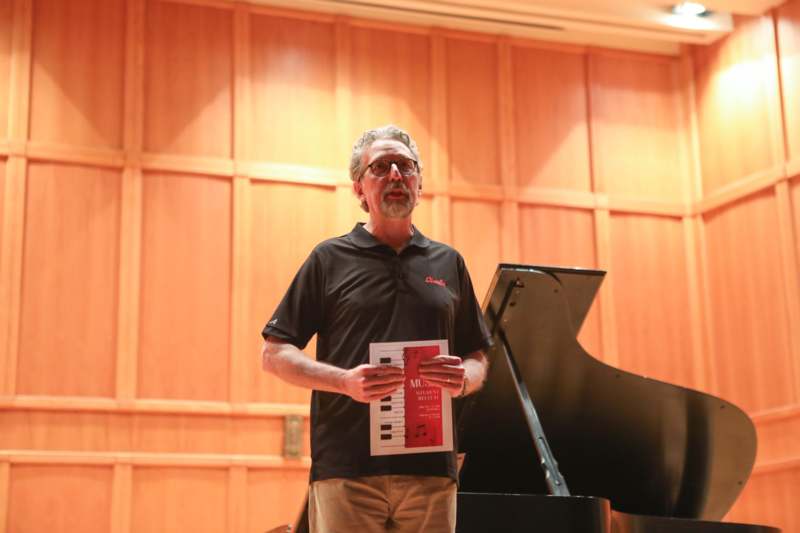 a man holding a sheet music