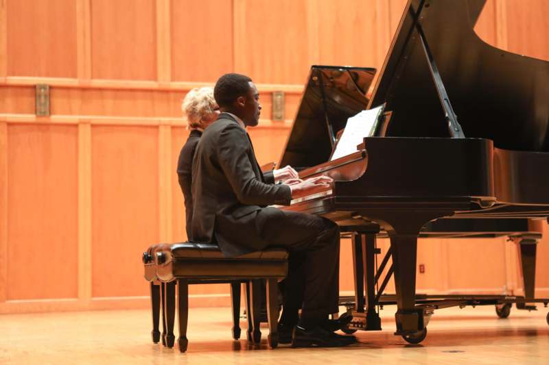 a man and woman playing piano