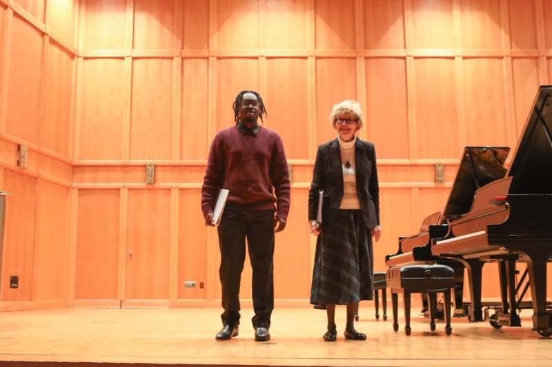 a man and woman standing on a stage