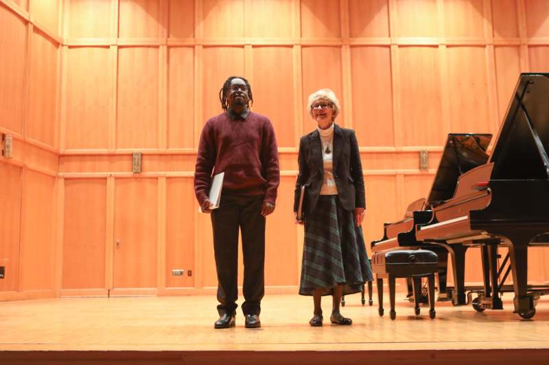 a man and woman standing on a stage