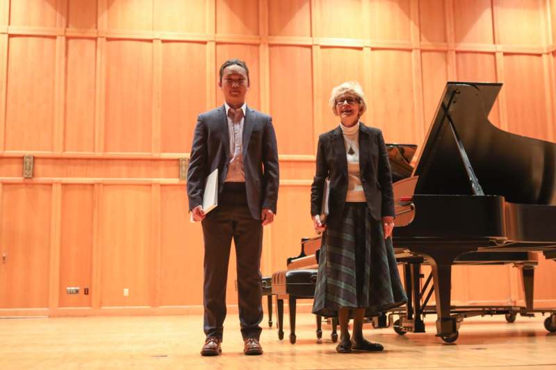 a man and woman standing on a stage