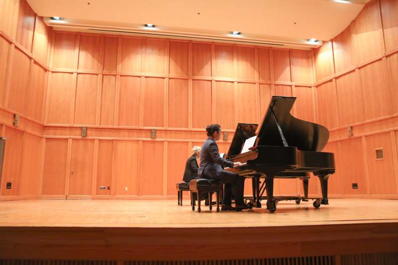 a woman playing a piano