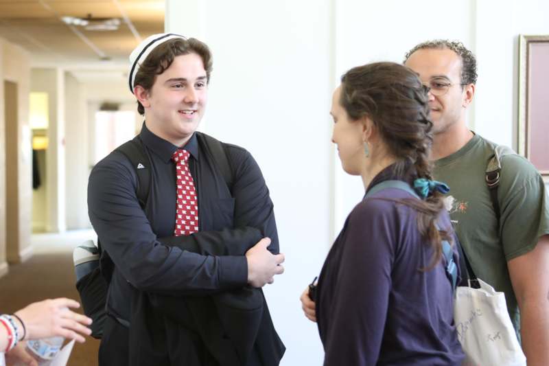 a man in a suit and tie with a woman in a white room