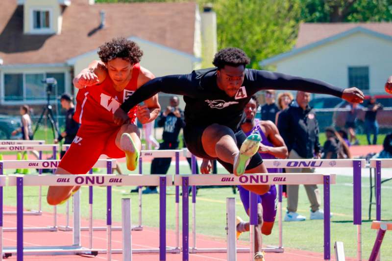 a group of people jumping over hurdles