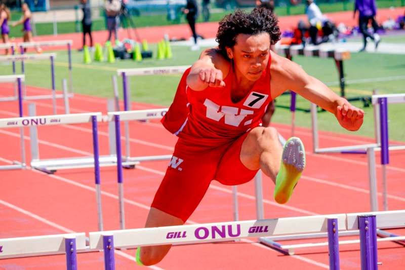 a person jumping over a hurdle