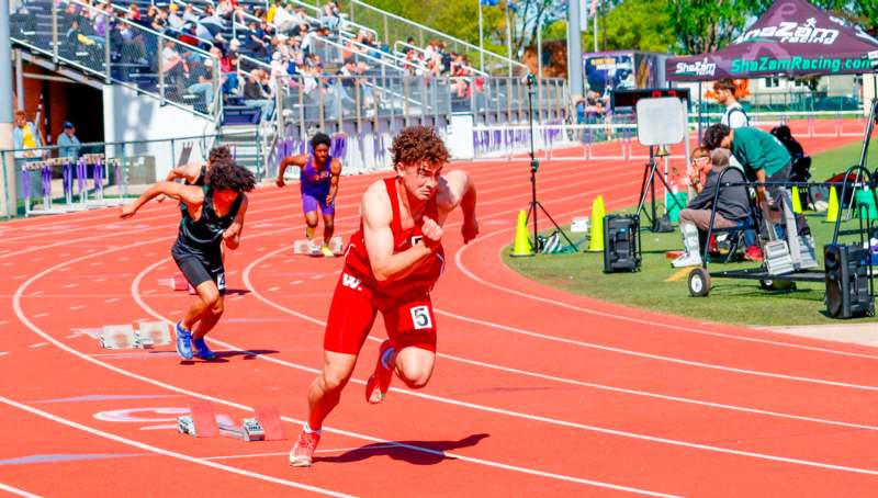 a group of people running on a track