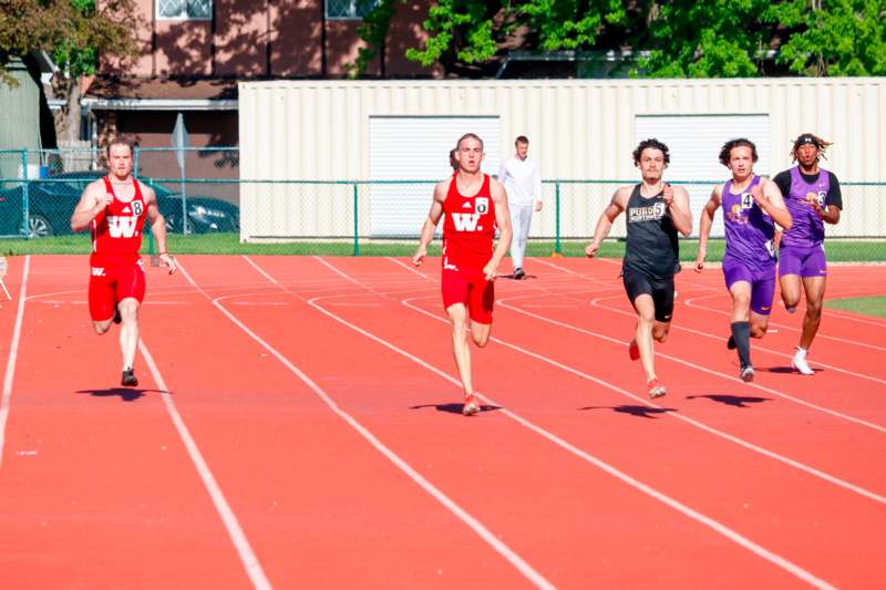 a group of people running on a track
