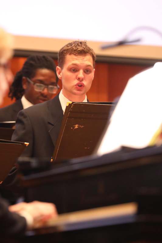 a man in a suit playing a music instrument