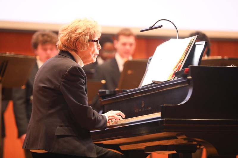 a woman playing a piano
