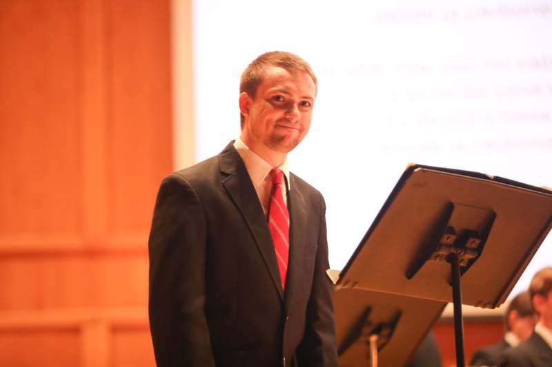 a man standing in front of a stand