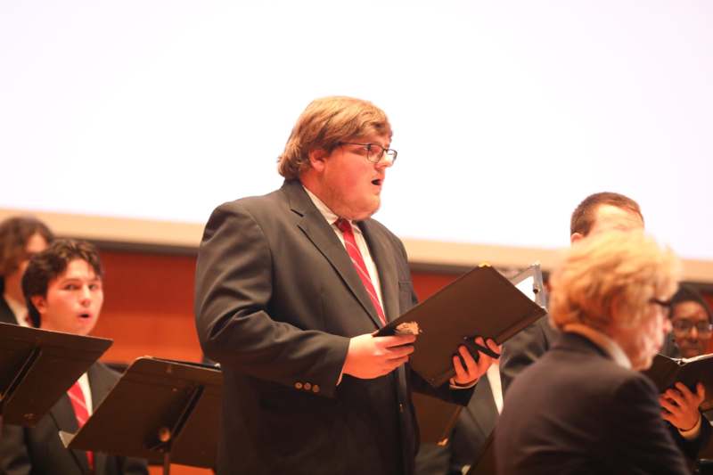 a man in a suit holding a folder