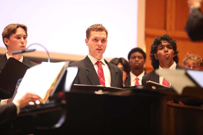 a group of men in suits and red ties