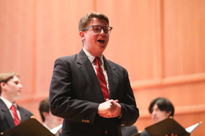 a man in a suit singing