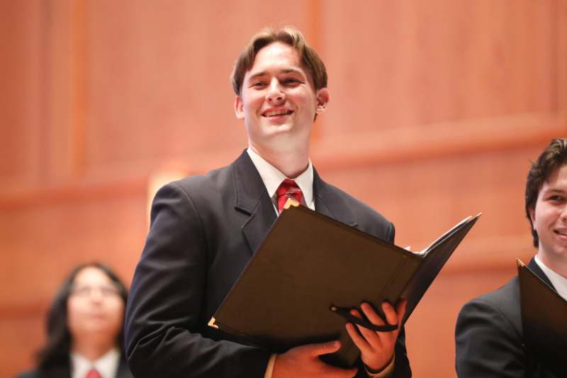 a man in a suit holding a folder