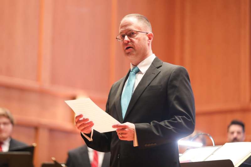 a man in a suit holding a piece of paper